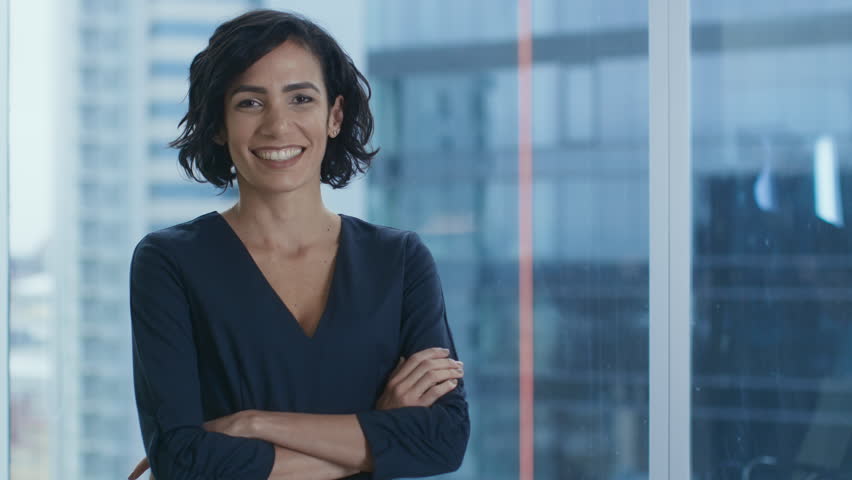 Portrait of the Successful Hispanic Businesswoman Crossing Her Arms and Smiling. Beautiful Female Executive Standing in Her Office. Shot on RED EPIC-W 8K Helium Cinema Camera. | Shutterstock HD Video #1016145793