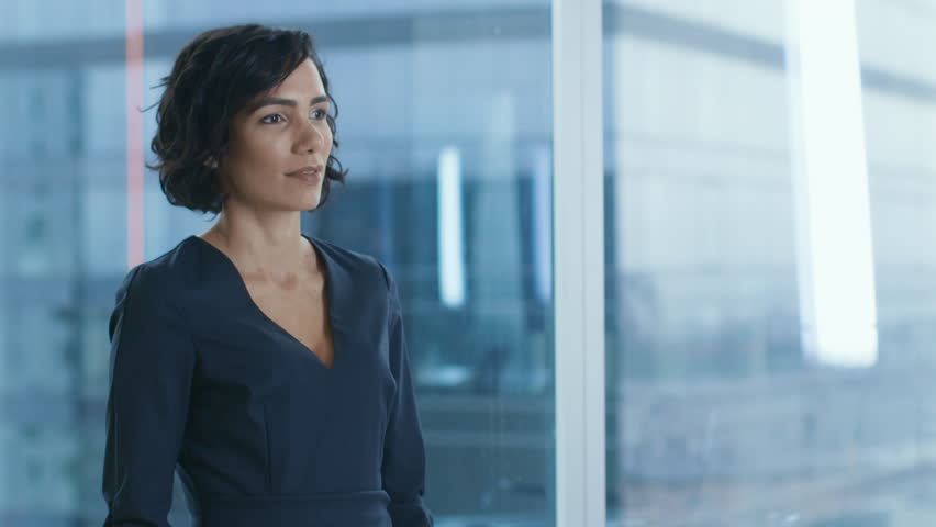 Portrait of the Successful Businesswoman Crossing Her Arms and Smiles. Beautiful Woman Executive Standing in Her Office. Shot on RED EPIC-W 8K Helium Cinema Camera. Royalty-Free Stock Footage #1016145799