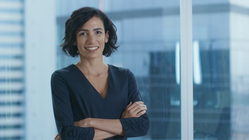 Portrait of the Successful Businesswoman Crossing Her Arms and Smiles. Beautiful Woman Executive Standing in Her Office. Shot on RED EPIC-W 8K Helium Cinema Camera. Royalty-Free Stock Footage #1016145799