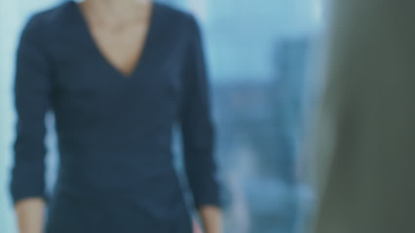 Out of Focus Businesswoman Shakes Her Hand with a Businessman. Hands in Focus. Finalizing the Deal and Concluding Contract with a Handshake. Shot on RED EPIC-W 8K Helium Cinema Camera. Royalty-Free Stock Footage #1016145844
