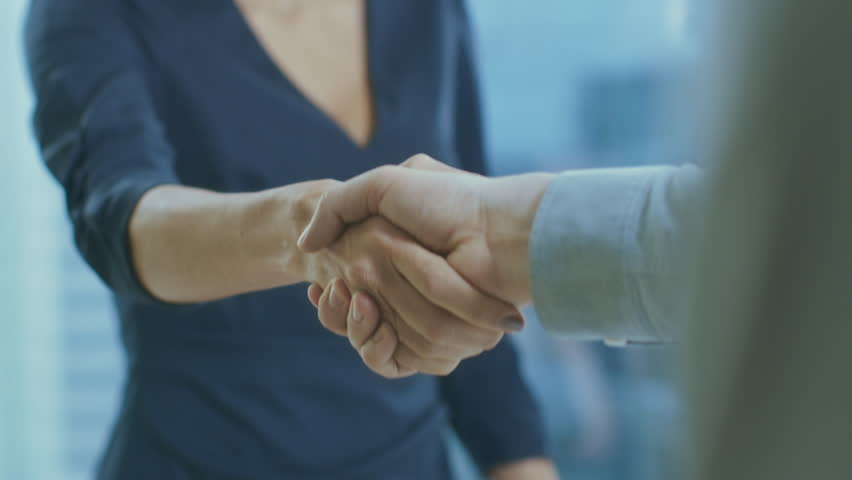 Out of Focus Businesswoman Shakes Her Hand with a Businessman. Hands in Focus. Finalizing the Deal and Concluding Contract with a Handshake. Shot on RED EPIC-W 8K Helium Cinema Camera.