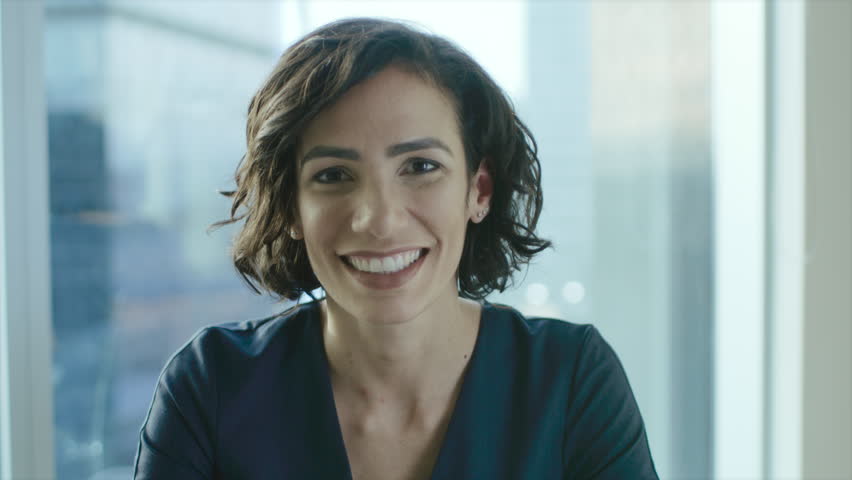 Portrait of a Beautiful Hispanic Woman Smiling Charmingly. Out of Focus Cityscape Background. Shot on RED EPIC-W 8K Helium Cinema Camera. | Shutterstock HD Video #1016145895