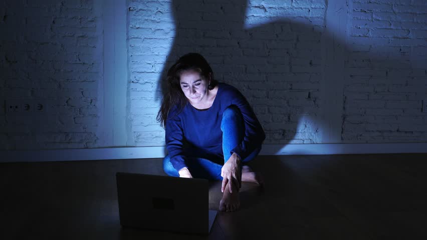 Sad and scared female Young woman with computer laptop suffering cyberbullying and harassment being online abused by stalker or gossip feeling desperate and humiliated in cyber bullying concept. | Shutterstock HD Video #1016148193