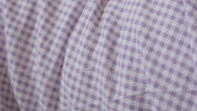 Shallow DOF purple bed sheet chequered fabrics slow pan 4K video