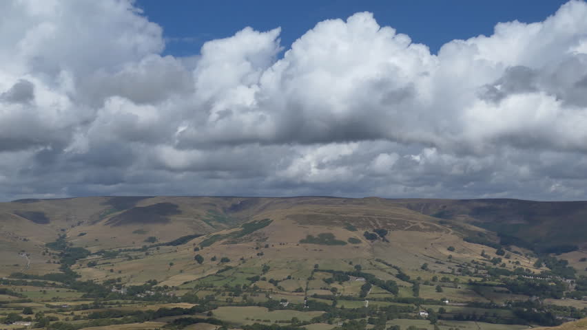 Fluffy clouds over the valley of fields and hills. England.
