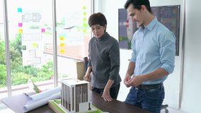 Architects and Businesswoman are working on a building model. Business woman suggest idea to designer at modern office. concept of construction, architecture, development and creative.