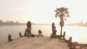 Slow motion shot of young woman running towards temples terrace by the lake at sunrise and outstretching arms for happiness and freedom. People travel discovery concept 