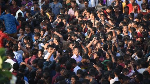AMRAVATI, MAHARASHTRA, INDIA 3 SEPTEMBER 2018 : Crowd of young of People gather together and dancing on road during the Dahi Handi festival to celebrate God Krishna's Birth. 