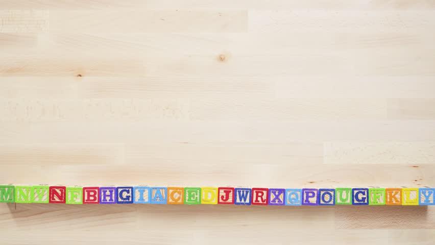 Word LEARN from multicolor wooden letters on wooden table.