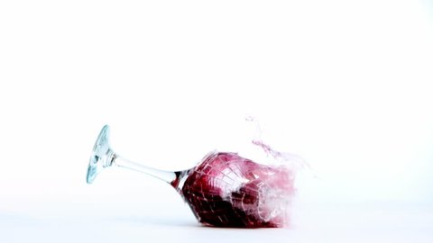 Super slow motion of falling glass of red wine, isolated on white background. Filmed on high speed cinema camera, 1000 fps.