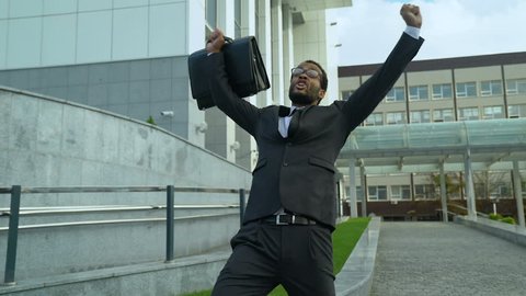 Extremely happy office manager shouting and dancing joyfully, promotion success