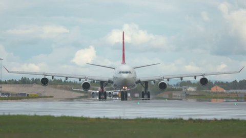 Oslo Airport Norway - ca September 2018: airplane turkish airlines huge airbus a340 in distance front view heading towards camera