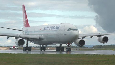 Oslo Airport Norway - ca September 2018: airplane turkish airlines huge airbus a340 approaching turning beautiful low angle view