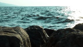 1920x1080 25 Fps. Sea Wave And Rocks with Sun Sparks Sun Video.