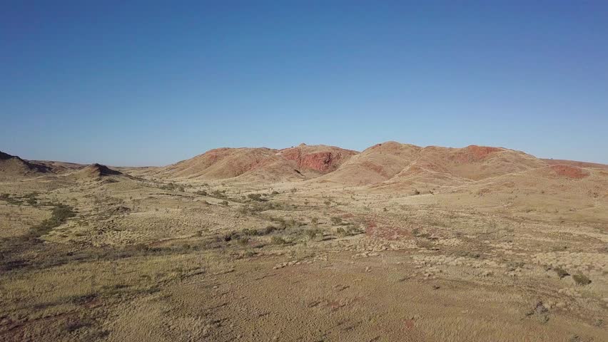 Flying towards vast country plains and mountain ranges at Marble Bar in Western Australia