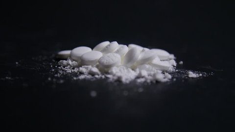 Hand Crushes Pills Into Powder in Slow Motion