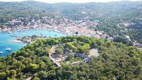 Aerial drone bird's eye view video of iconic castle in Agios Nikolaos islet nexti to small safe port of Gaios, Paxos island, Ionian, Greece