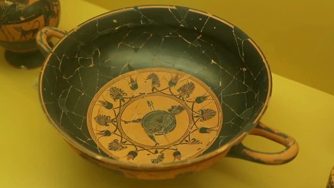 Black clay kylix with warrior, ancient Greek pottery art, Agora museum exhibit