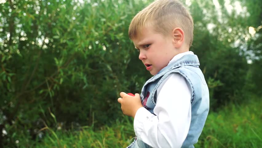 The little boy is crying and screaming. The child shed tears. Kid mad at mom. The boy is sad and crying. The child became hysterical. Royalty-Free Stock Footage #1016192200