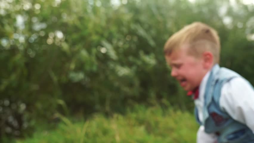 The little boy is crying and screaming. The child shed tears. Kid mad at mom. The boy is sad and crying. The child became hysterical. Royalty-Free Stock Footage #1016192212