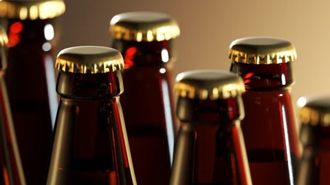 Two rows of fresh, brown beer bottles in a closeup view. Golden caps shining in a warm, soft factory light.Full bottles of golden liquid as a symbol of fun and prosperity. Endless, seamless loop.

