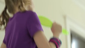 Low angle view of cheerful girl dancing and singing at home