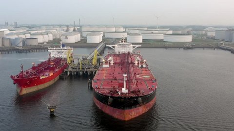 LNG Supertankers Docked in Port Awaiting Offloading and Loading of Fuels and Cargo