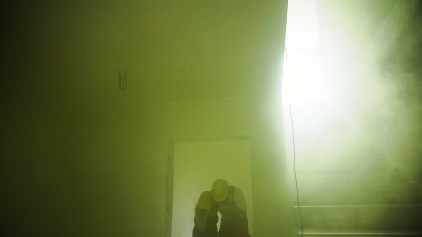 Woman and man workers suffocating at the construction site. | Shutterstock HD Video #1016211523
