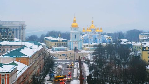 Kyiv, Ukraine. Video of sunset in Kyiv, Ukraine, with a view of the St Michaels Golden - Domed Monastery and traffic on a winter day with a gloomy sky. 