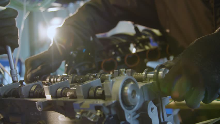 Hand of mechanic unscrews bolt of a car engine at service station. Slow motion Royalty-Free Stock Footage #1016228926