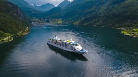 Cruise Ship, Cruise Liners On Geiranger fjord, Norway. It is a 15-kilometre (9.3 mi) long branch off of the Sunnylvsfjorden, which is a branch off of the Storfjorden (Great Fjord).