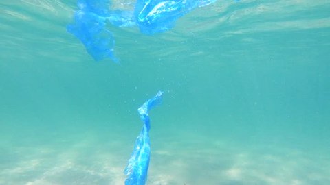 Plastic pollution in ocean environmental problem. Bags dumped in sea วิดีโอสต็อก