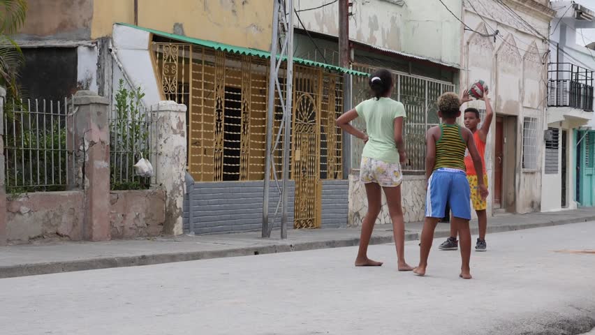 Santiago de Cuba / Cuba - July 17 2018: Poor Kids Play Football Soccer On The Old Street Santiago de Cuba | Shutterstock HD Video #1016236354