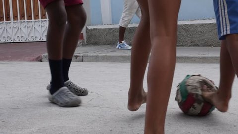 Santiago de Cuba / Cuba - July 17 2018: Poor Kids Play Football Soccer On The Old Street Santiago de Cuba