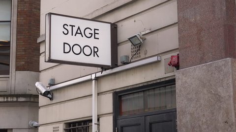 CIRCA 2018 - A generic stage door leads actors and performers to the backstage of a local theater in London, England.