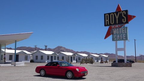 CIRCA 2018 - Establishing shot of a lonely desert gas station and hotel motel cafe in the Mojave Desert with Thunderbird car in forground.