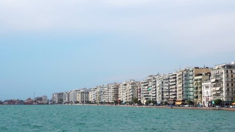 Beautiful low angle steady view on crowded modern hotel villas sea front quay of Thessaloniki port city Greece seascape