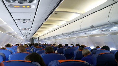 Moscow, Russian Federation – March 19, 2017: Interior of airplane with passengers on seats.