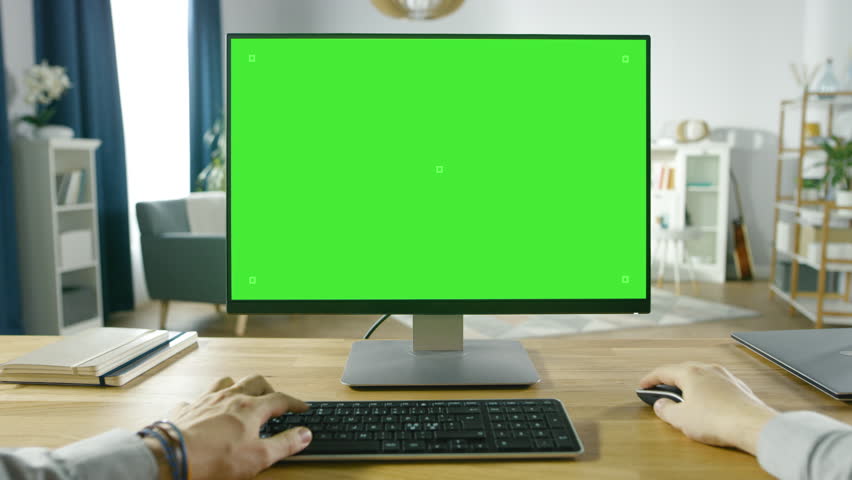 First Person View of Professional Freelancer Working on Green Mockup Screen Personal Computer From Home. Man Types, Browsing Through the Internet, Using Computer. Shot on RED EPIC-W 8K Helium Camera. Royalty-Free Stock Footage #1016262022