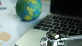 Focus Stethoscope Doctor table on laptop computer with report analysis and money about Healthcare costs and fees in medical hospital office. Healthcare budget and business concept, 4k video - Powered by Shutterstock - Get 15% off with code: PIKWIZARD15