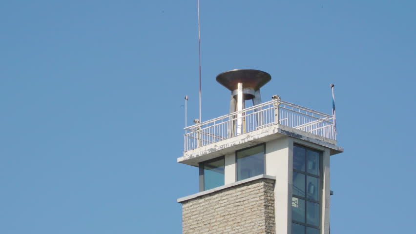 The tip of the tall tower building in Tallinn Estonia with the glass windows of the buildings