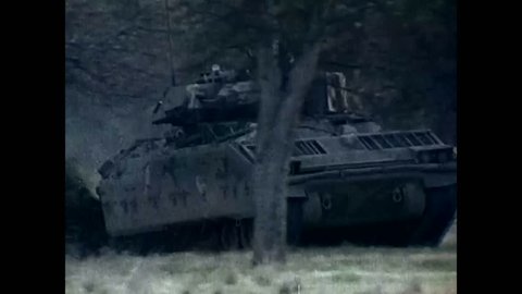 CIRCA 1980S - An animated armor system is shown as well as a Bradley Fighting Vehicle in transit over rough terrain and under fire.