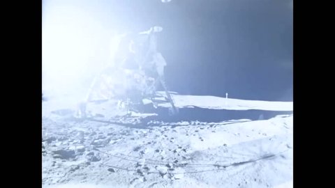 CIRCA 1971 - Alan Shepard and Edgar Mitchell plant an American flag on the moon.