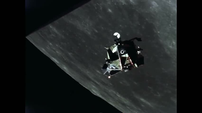 CIRCA 1969 - A camera on Apollo 11 films a satellite near it in lunar orbit. Royalty-Free Stock Footage #1016276524
