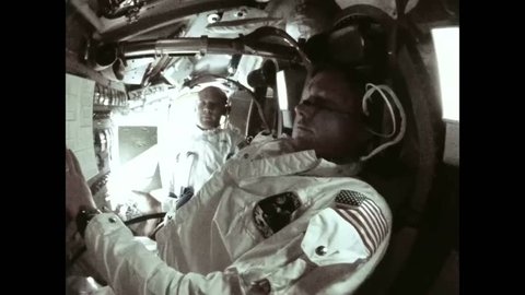 CIRCA 1969 - The Apollo 11 crew films each other on board, then the lunar surface as they fly over it.