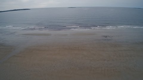 empty sandy beaches of ocean during low tide