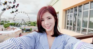 beauty woman take phone selfie happily in the amusement park