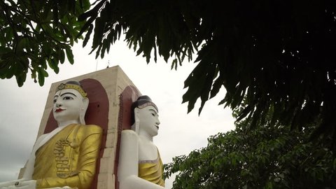 Four Faces of Buddha at Kyaikpun Buddha, in Bago, Myanmar, in the rainy season