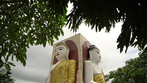 BAGO,MYANMAR - AUGUST 19,2018 : Four Faces of Buddha at Kyaikpun Buddha, in Bago, Myanmar, in the rainy season