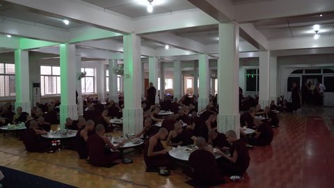 BAGO, MYANMAR -August 19, 2018: Monks having lunch in the monastery at Bago Myanmar. Buddhism in Myanmar is predominantly of the Theravada tradition, practised by 89% of the country's population
